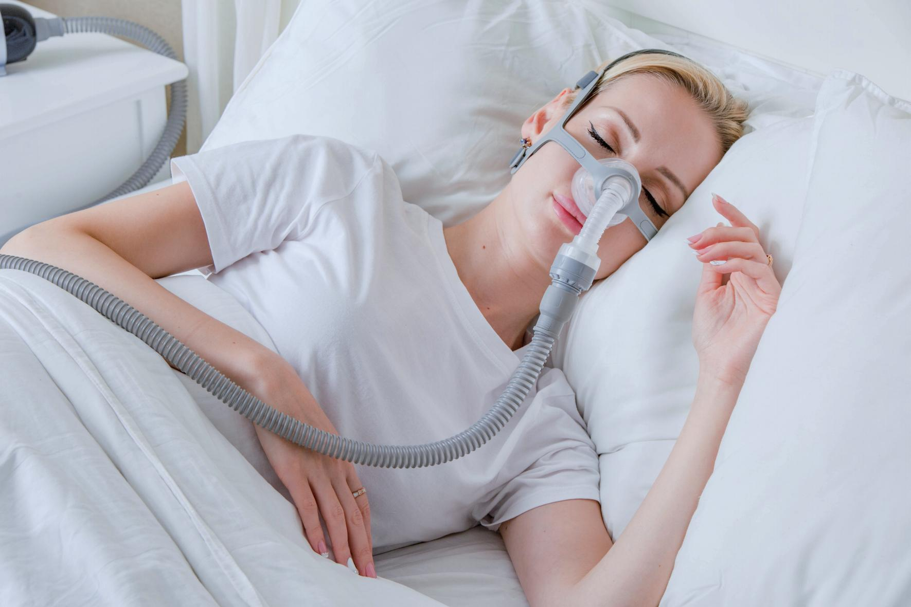 An adult woman resting with a respiratory mask